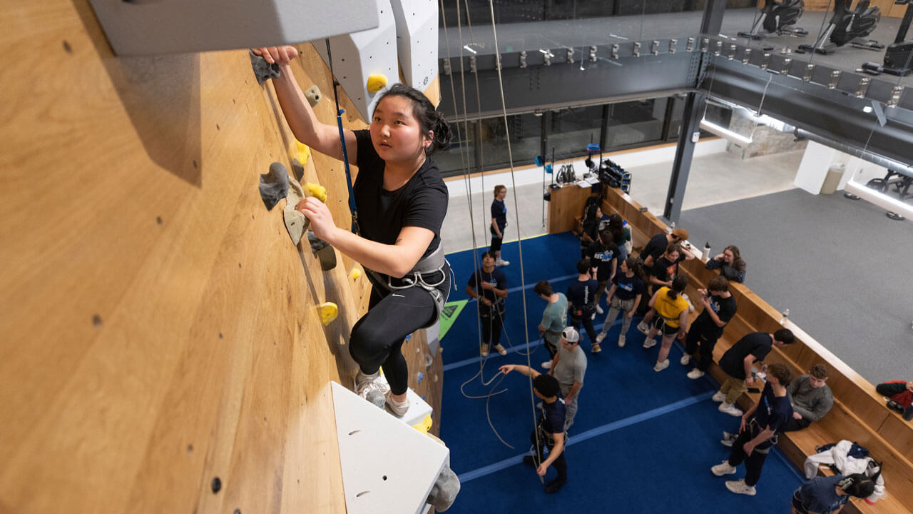 Student climbing on the rock wall