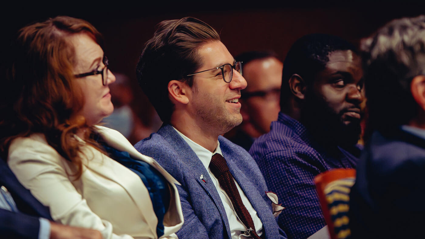 Attendees listen to a keynote speaker at the School of Medicine Symposium.