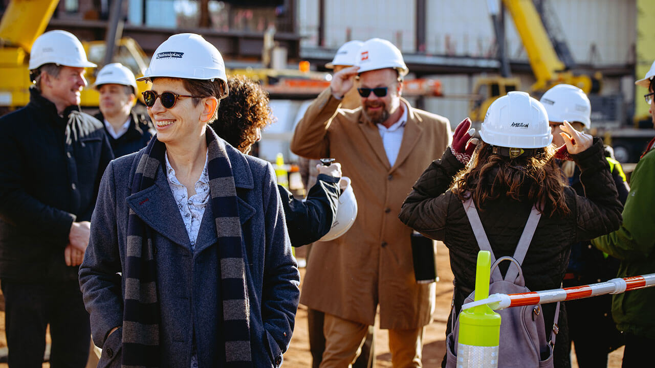 Debra Liebowitz smiling in front of the construction on the South Quad.