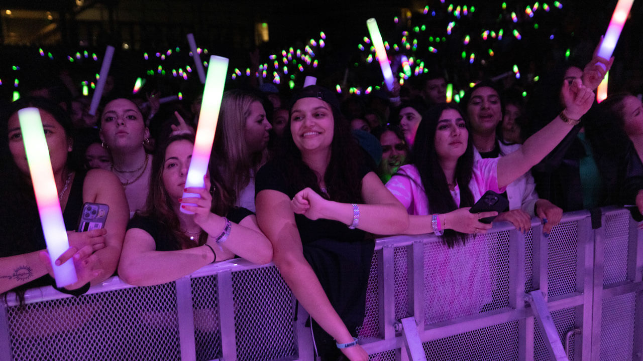 Students hold up glow sticks at Wake the Giant during Offset's performance