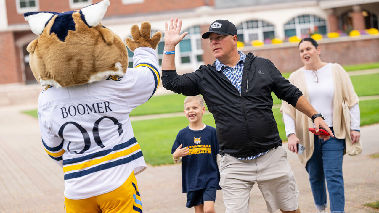 Parent high -fives Boomer with child excited in the background