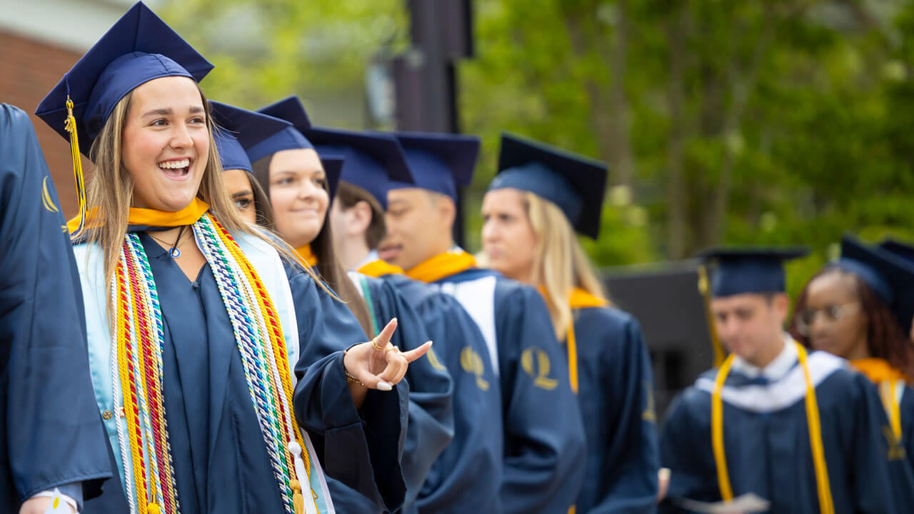 CAS Graduate looking at family during precession