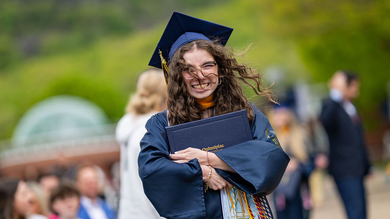 graduate hugs diploma