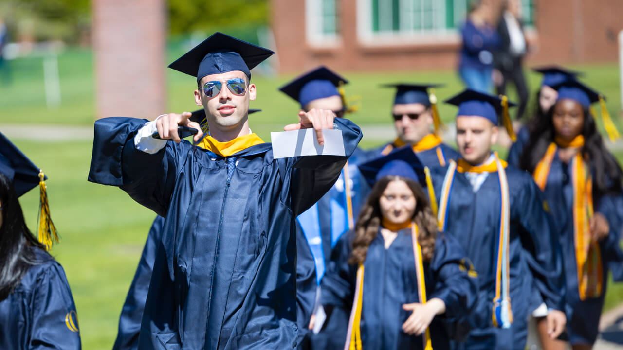 Students point at camera