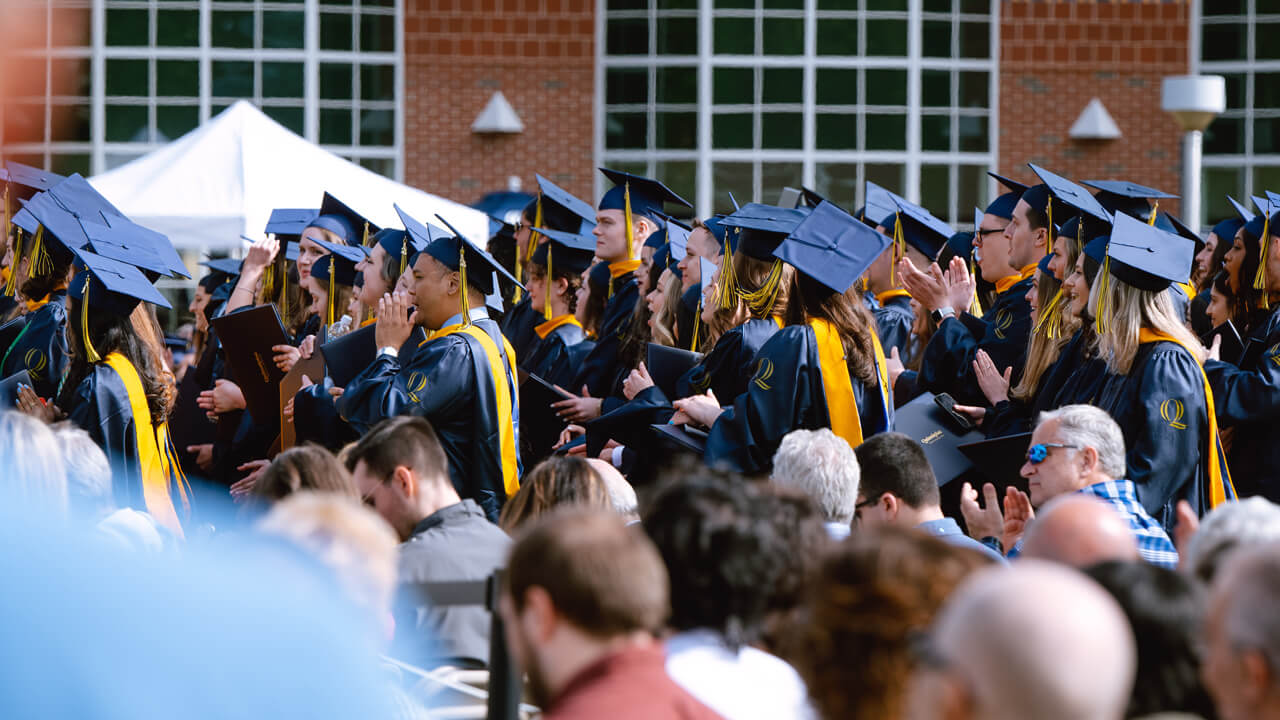 Students stand in the crowd