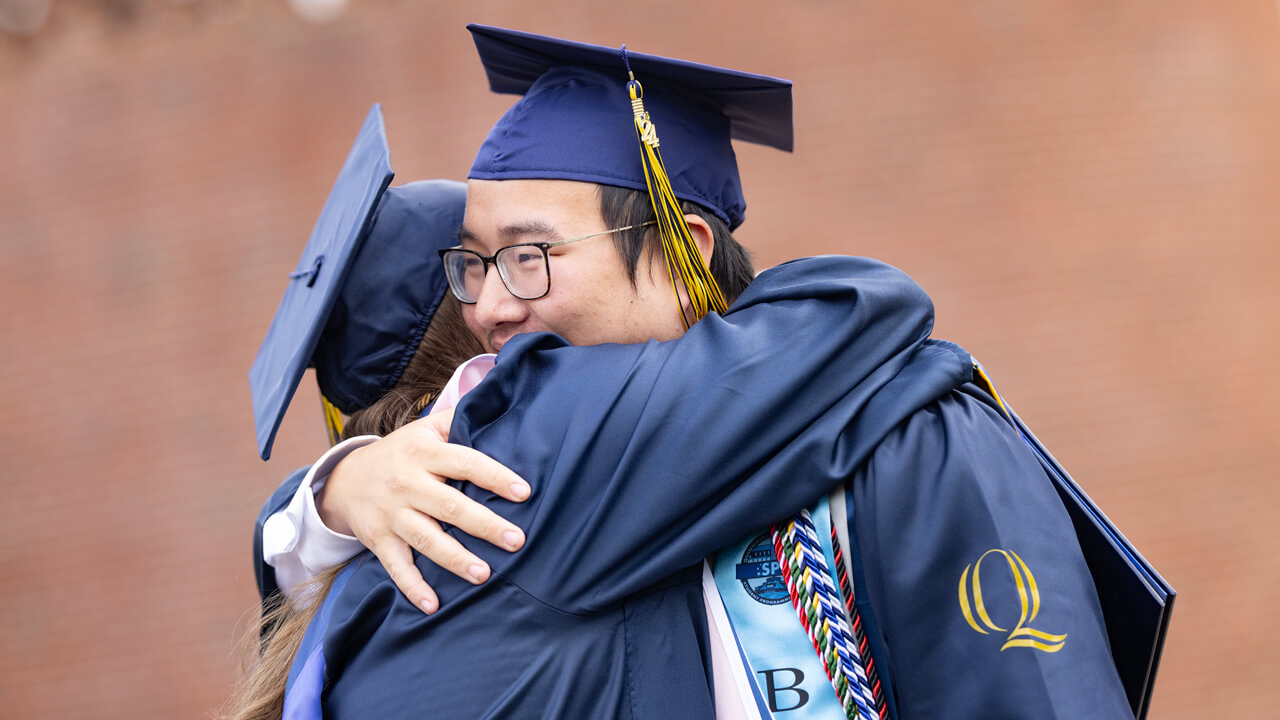 Two students hugging