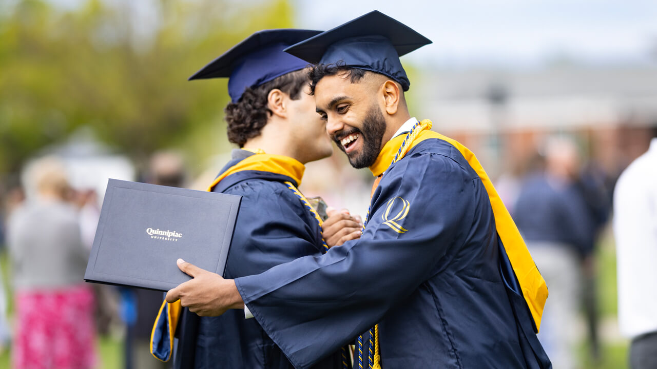 Two students shake hands