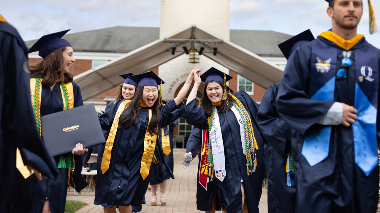 Students hold hands