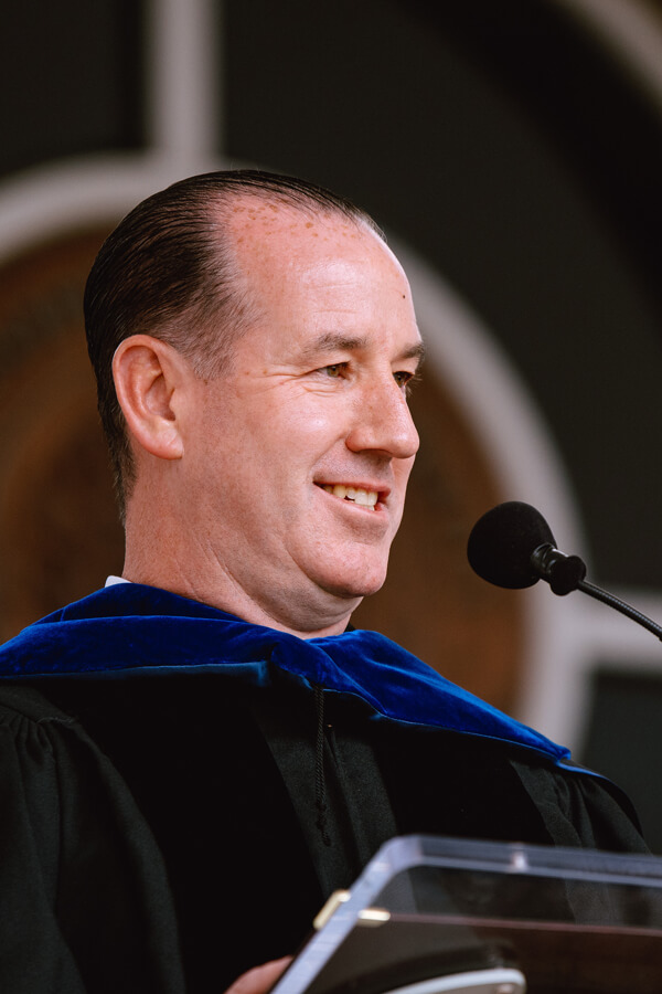 Jon-Paul Venoit delivers his keynote address from the podium during Commencement