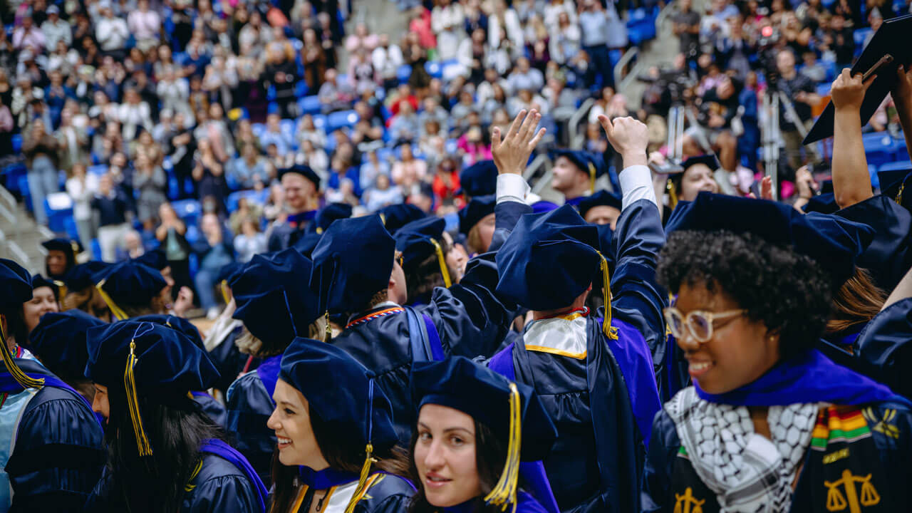 The class of 2024 law graduates celebrate enthusiastically after receiving their diplomas.