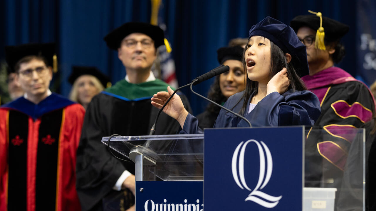 School of Medicine student sings national anthem at podium