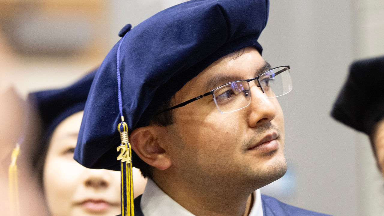 Medicine student wearing Class of 2024 tassel looking at commencement stage