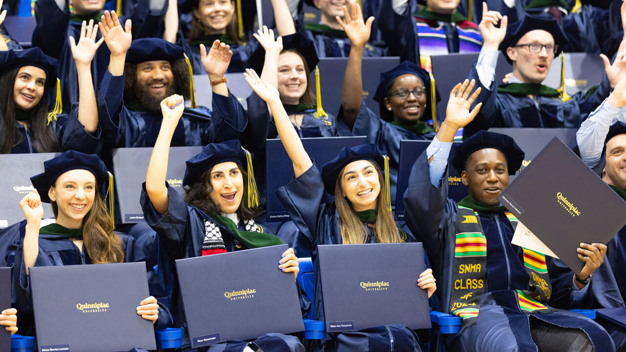 School of Medicine students smiling with their diplomas