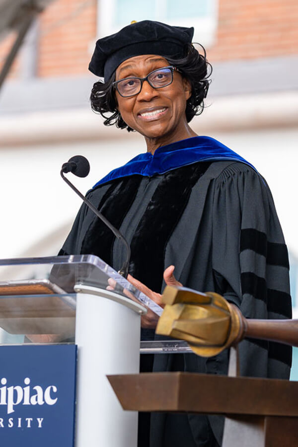 Charlene Russell-Tucker speaks at a podium during Quinnipiac Commencement