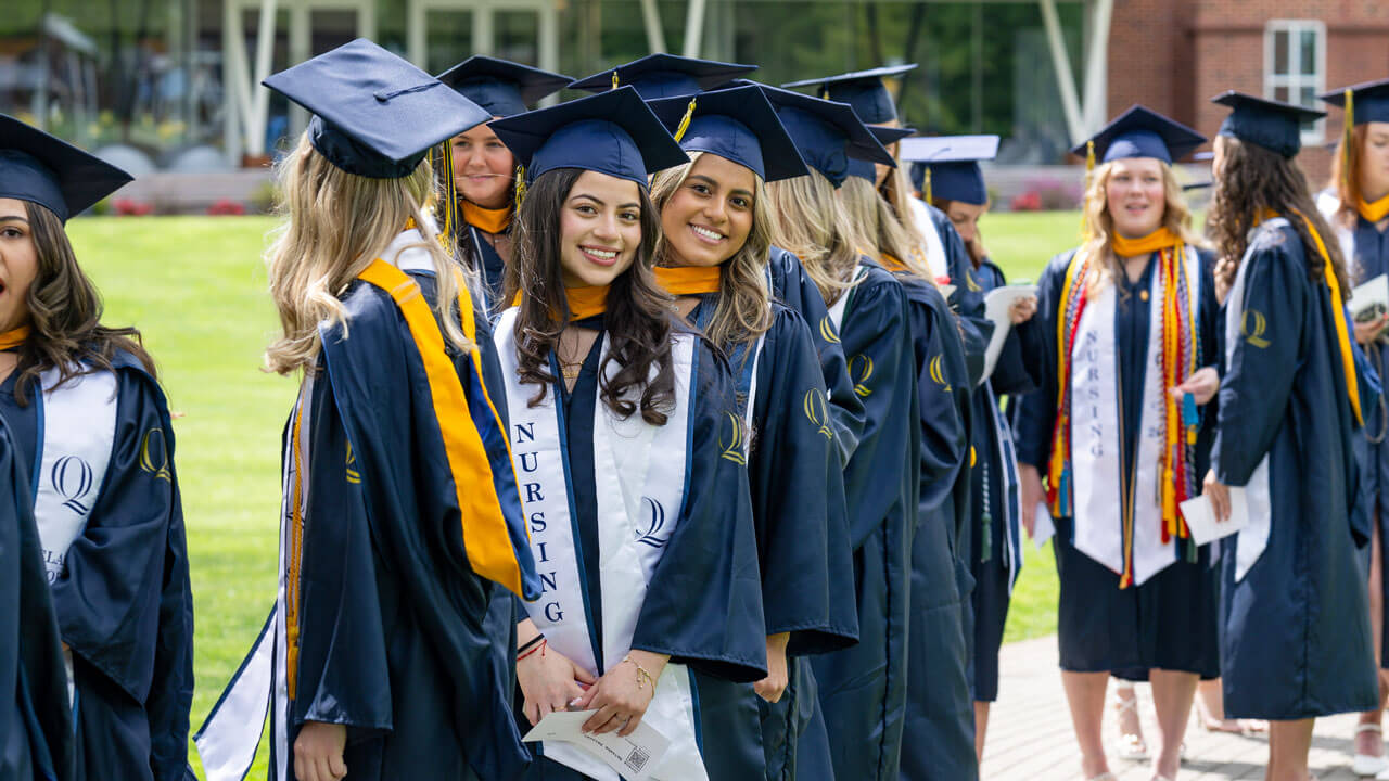 Two class of 2024 School of Nursing graduates grin for a photo before the Commencement ceremony begins.