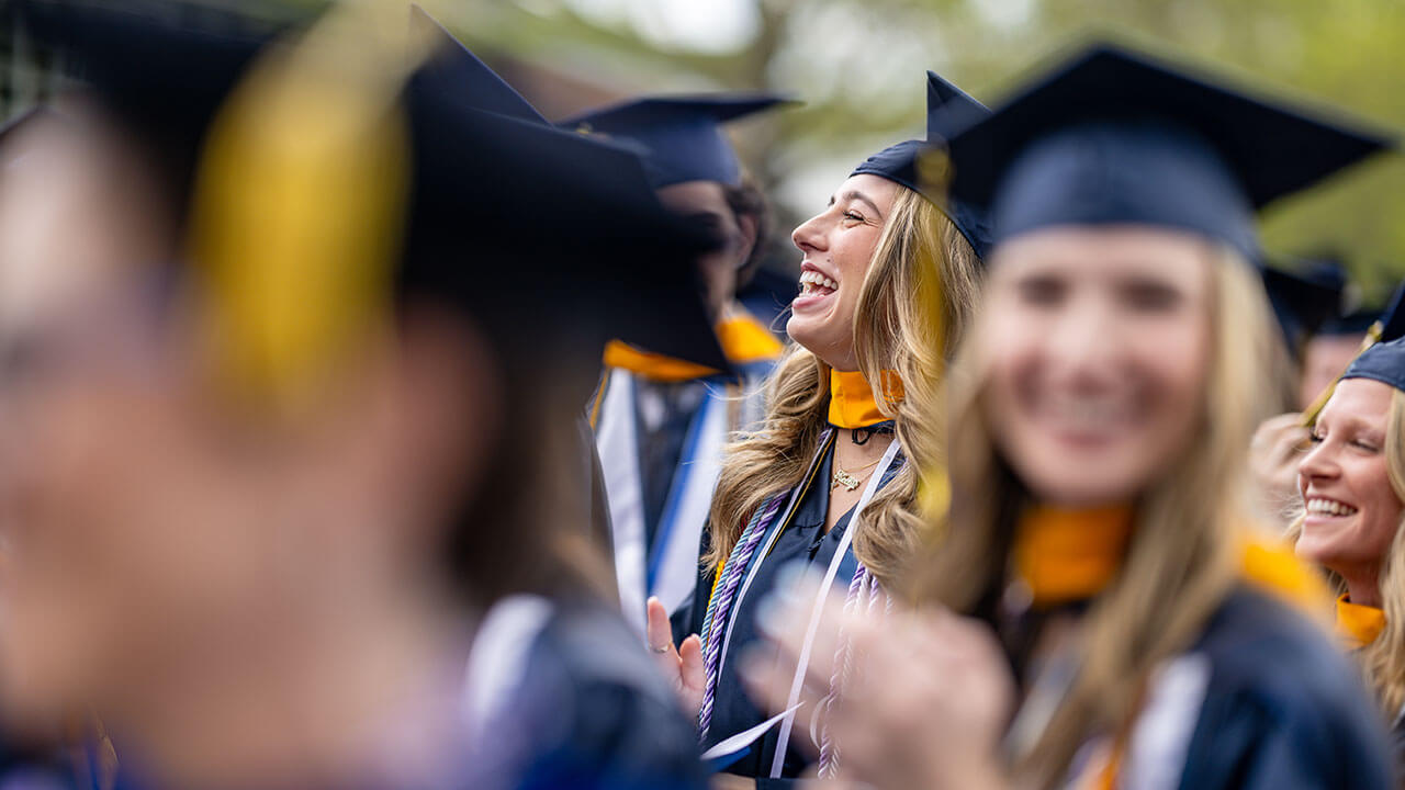 graduates smile and laugh