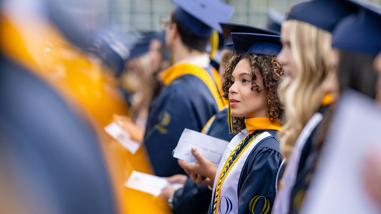 graduates stand in their line