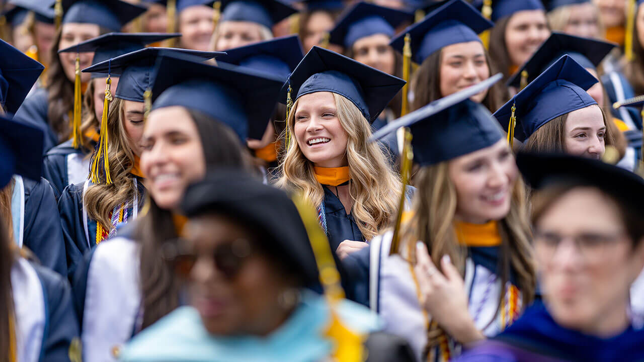 graduates smile in the audience