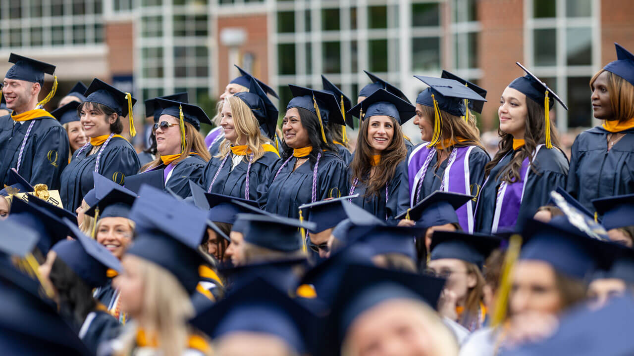 The School of Education Class of 2024 stands in anticipation during the ceremony.