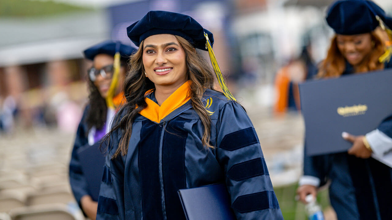 Graduate smiling and gazing into the distance