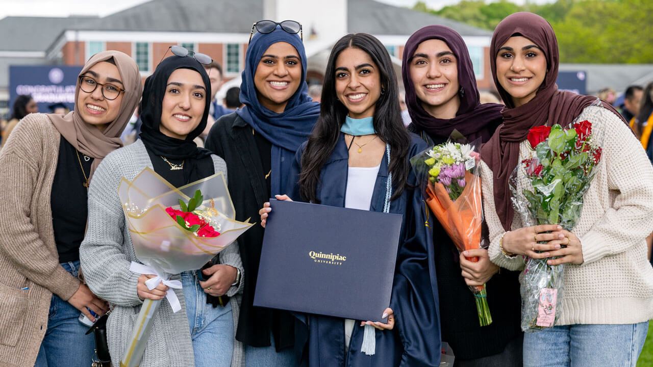 Quinnipiac graduate takes a photo with their family