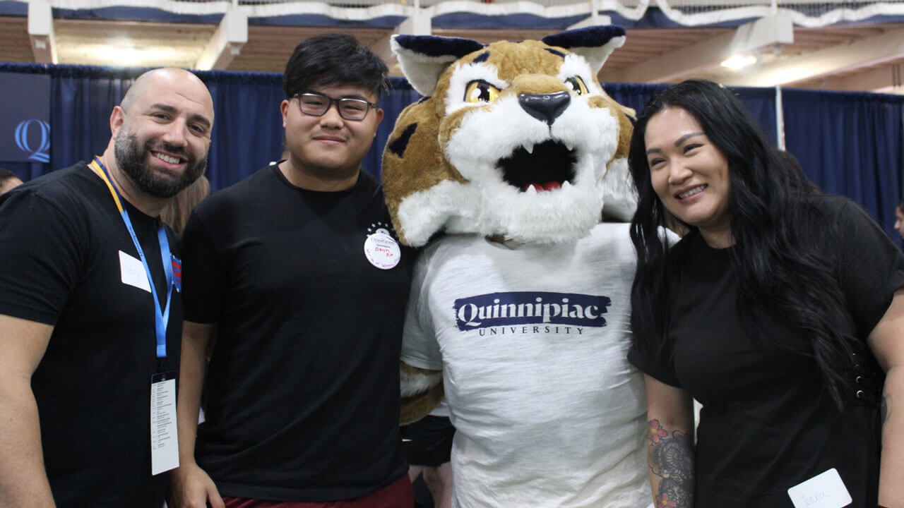 Orientation family smiles for a photo with Boomer