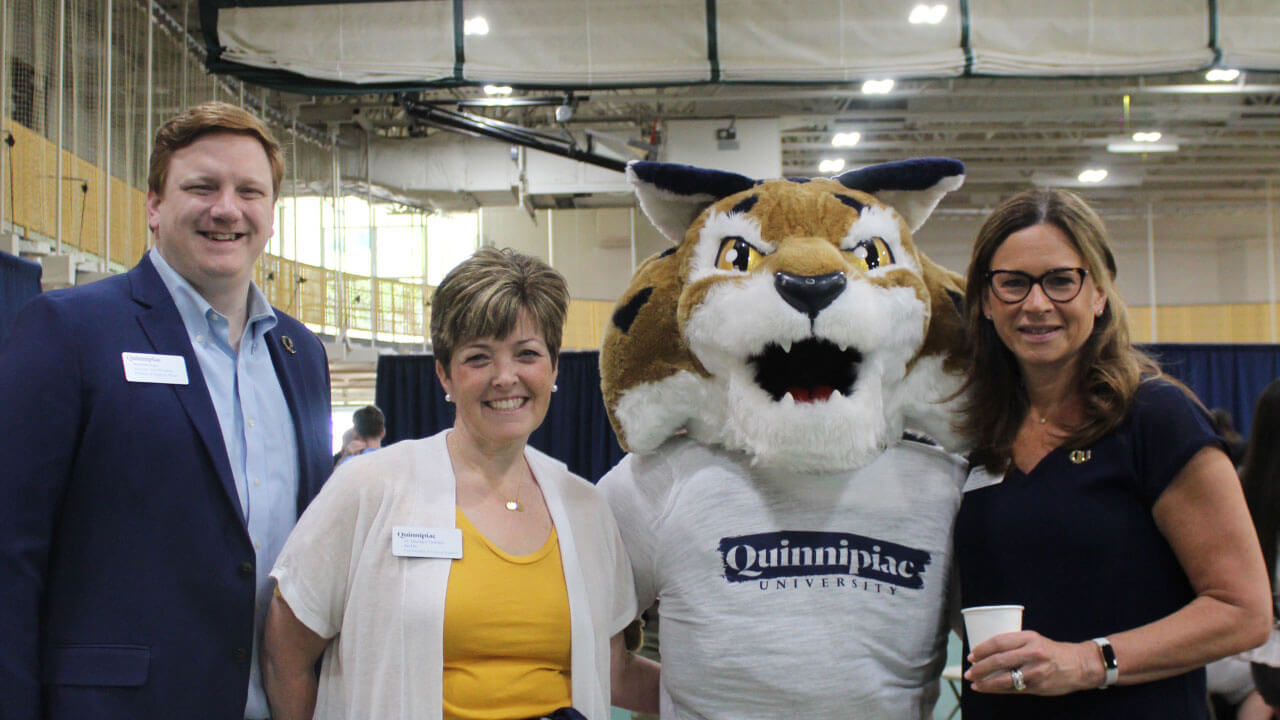 Boomer poses with Quinnipiac staff