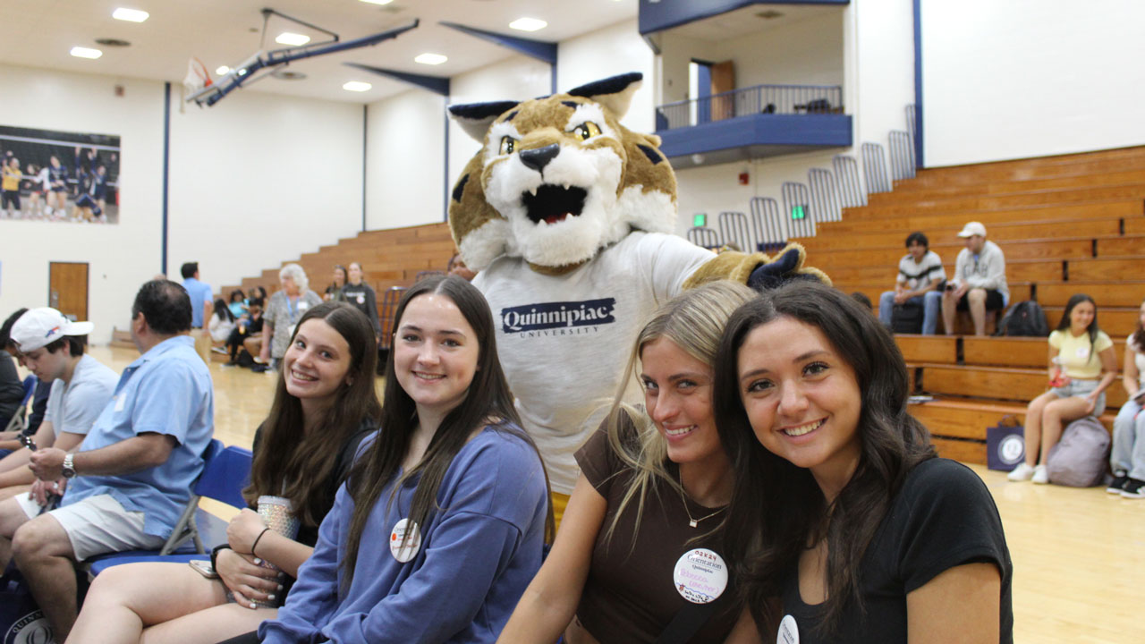 Boomer poses behind students sitting