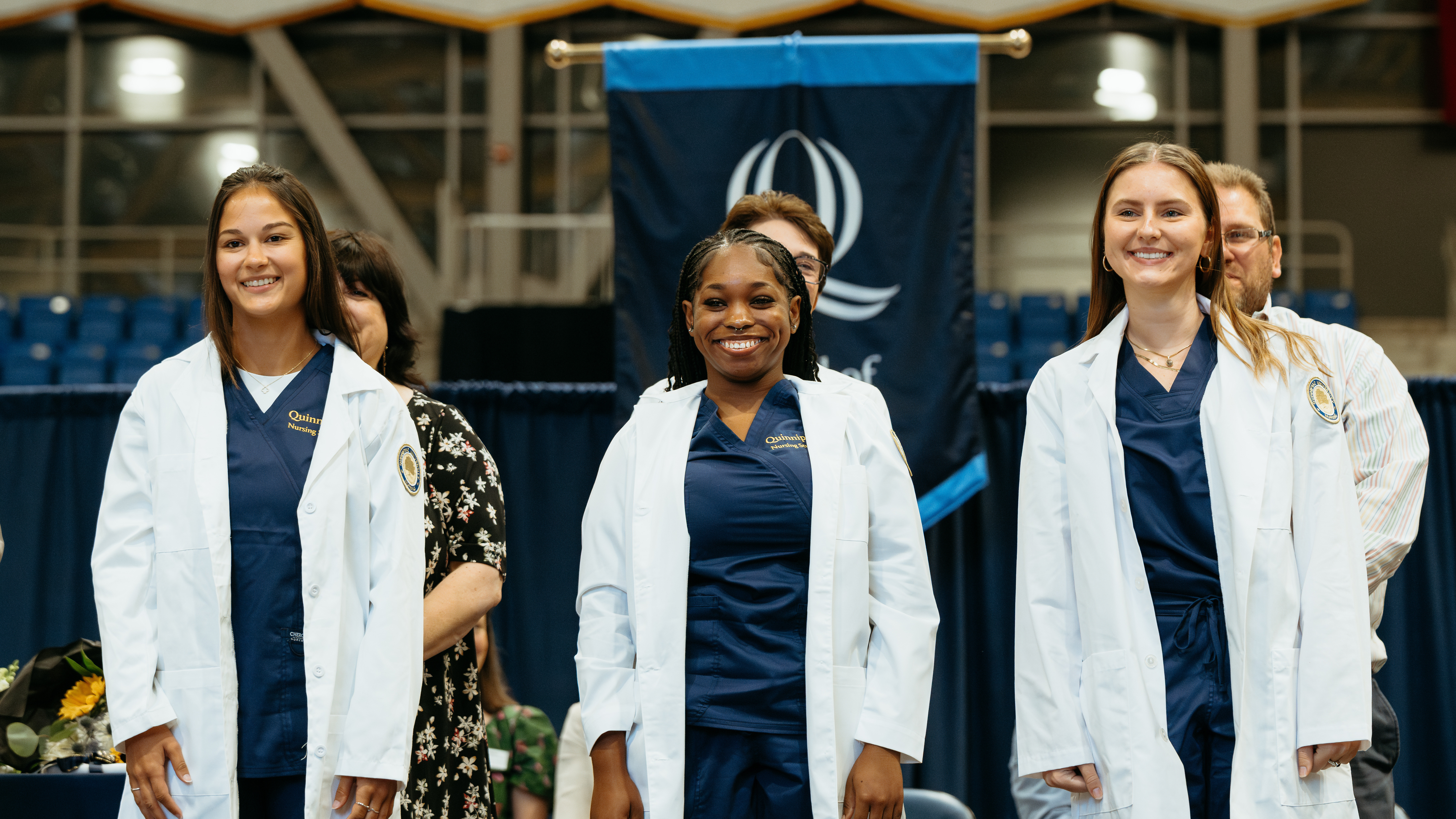 Students stand on stage