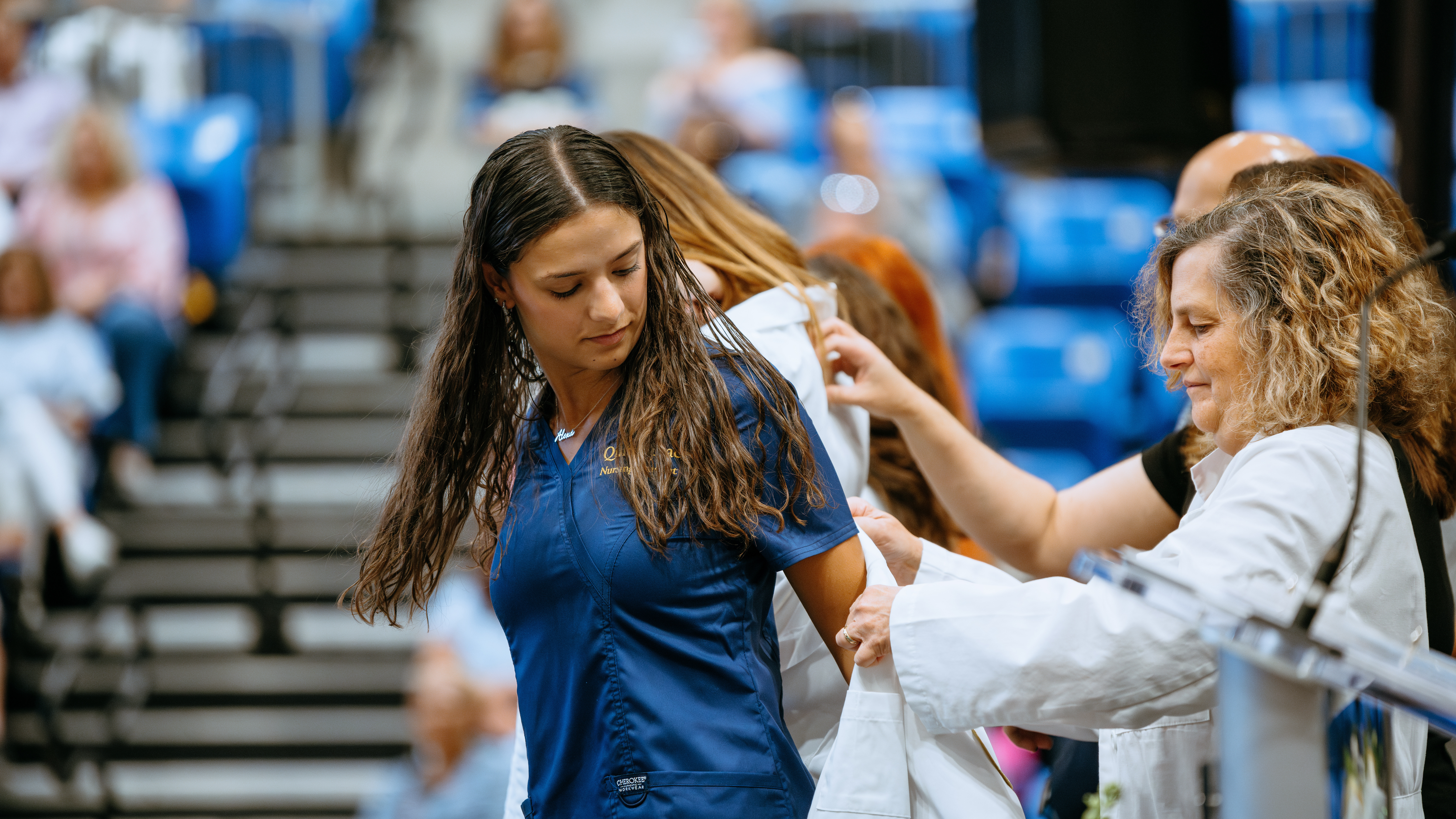 Student puts on white coat