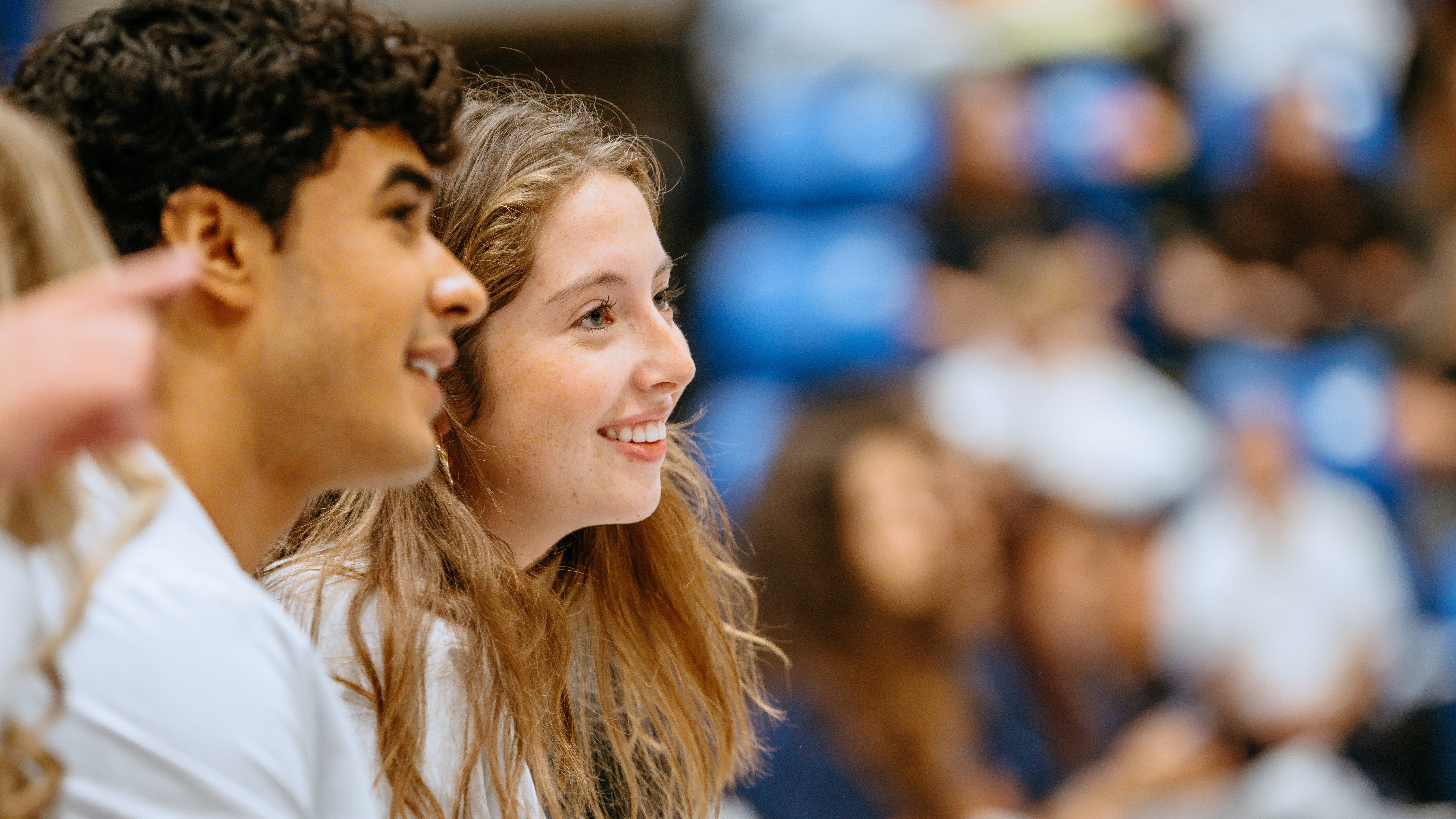 Two happy students sitting together