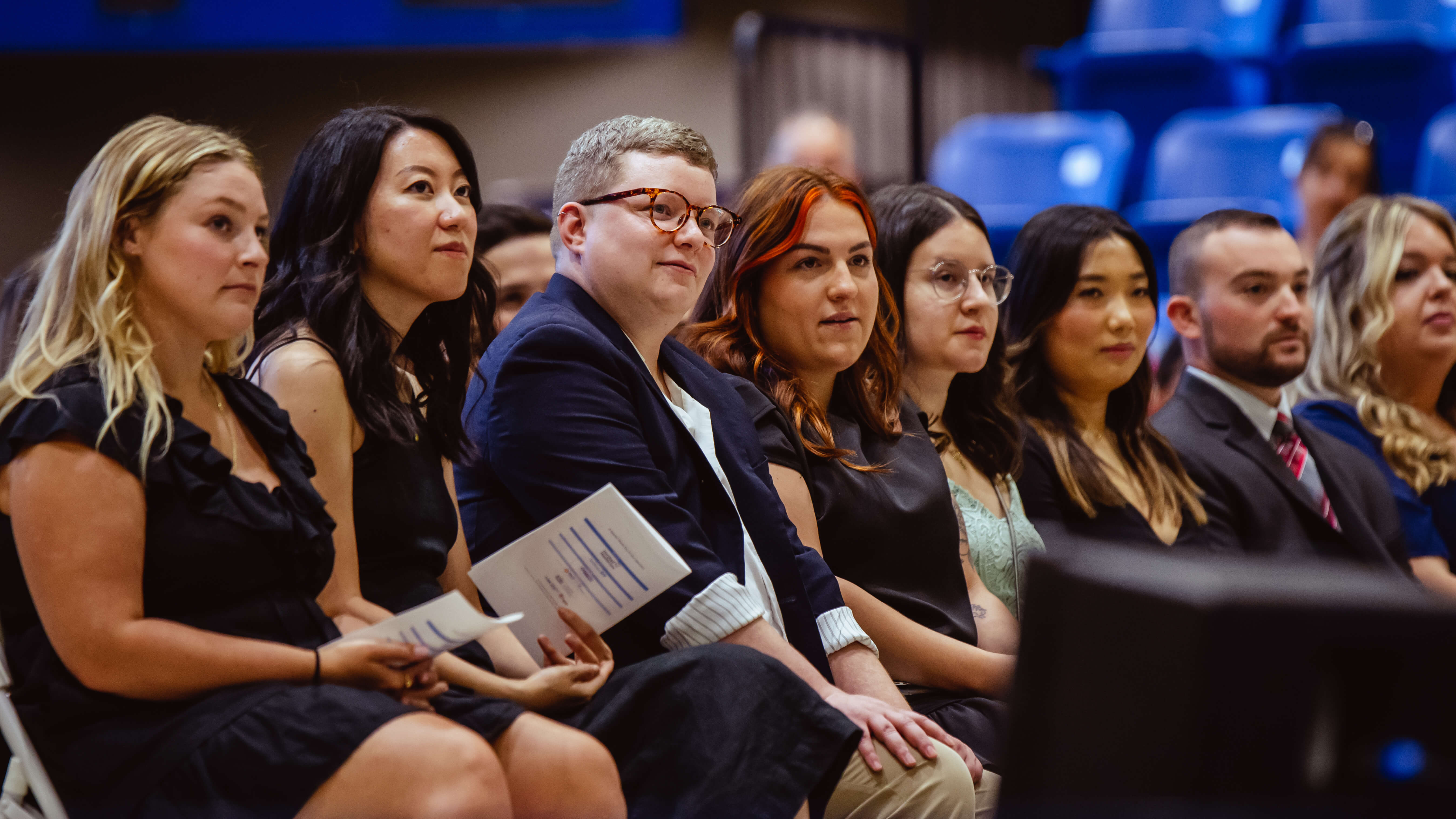 Students sit and listen to guest speakers during the Pinning Ceremony