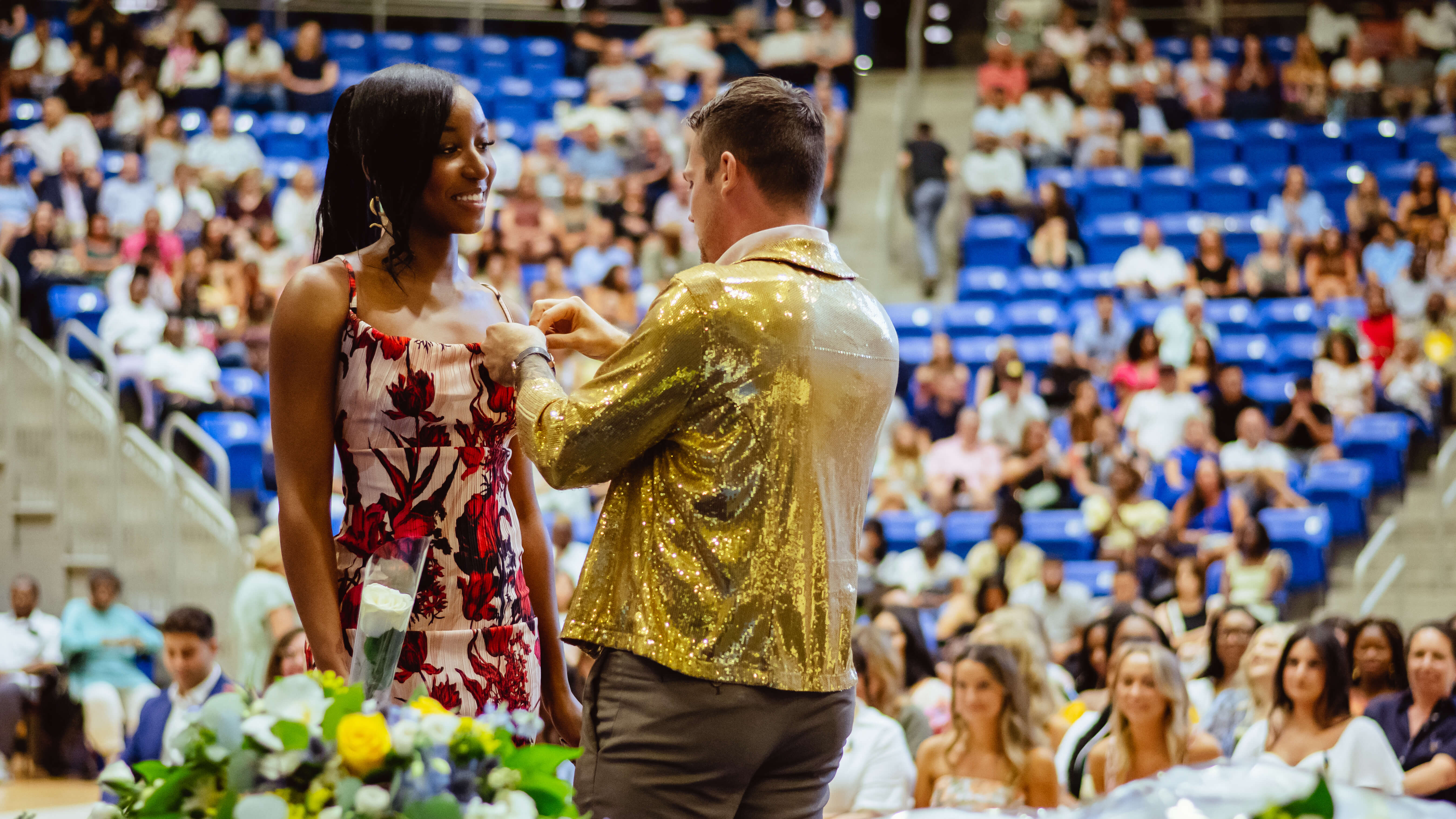 A student receives her pin on stage