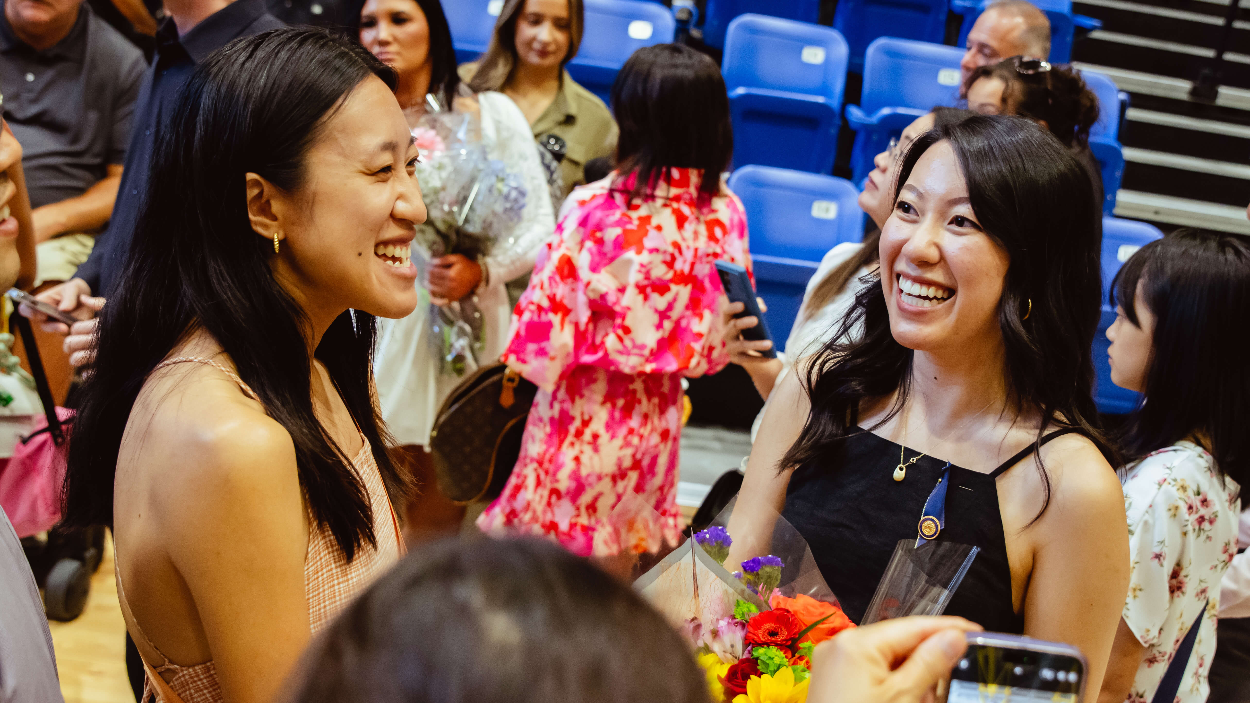 Family and friends smile and celebrate the newly appointed nurses