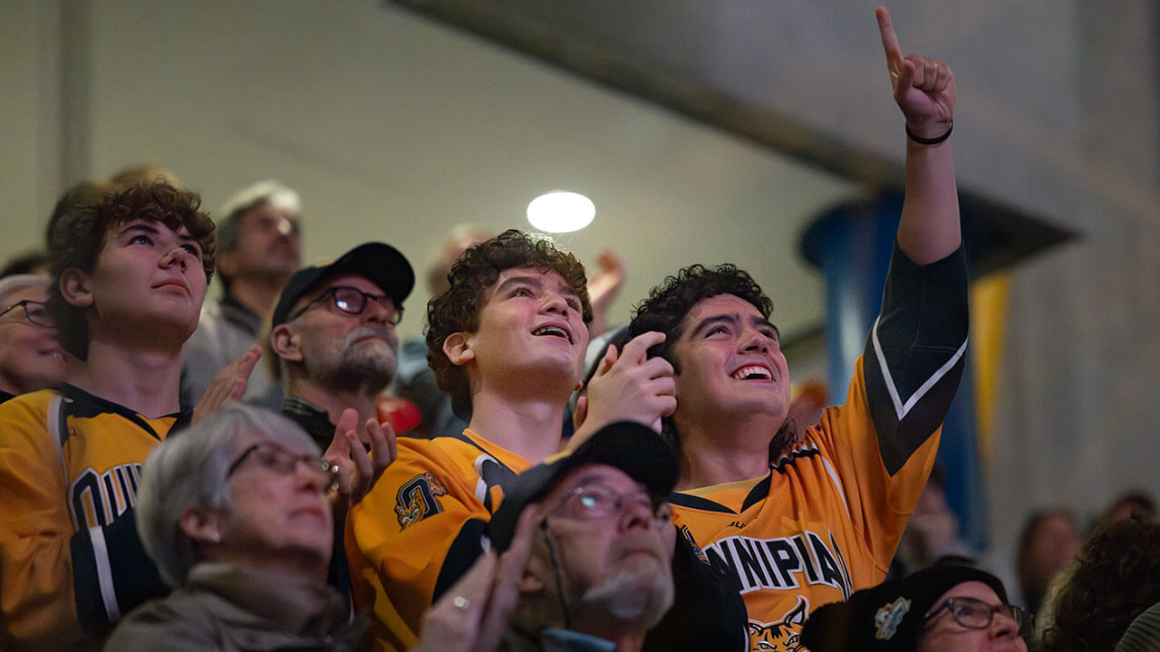 Two fans cheer loudly in the crowd