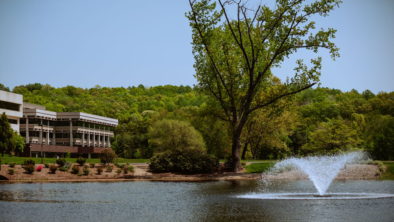 A wide shot of the North Haven campus and pond.