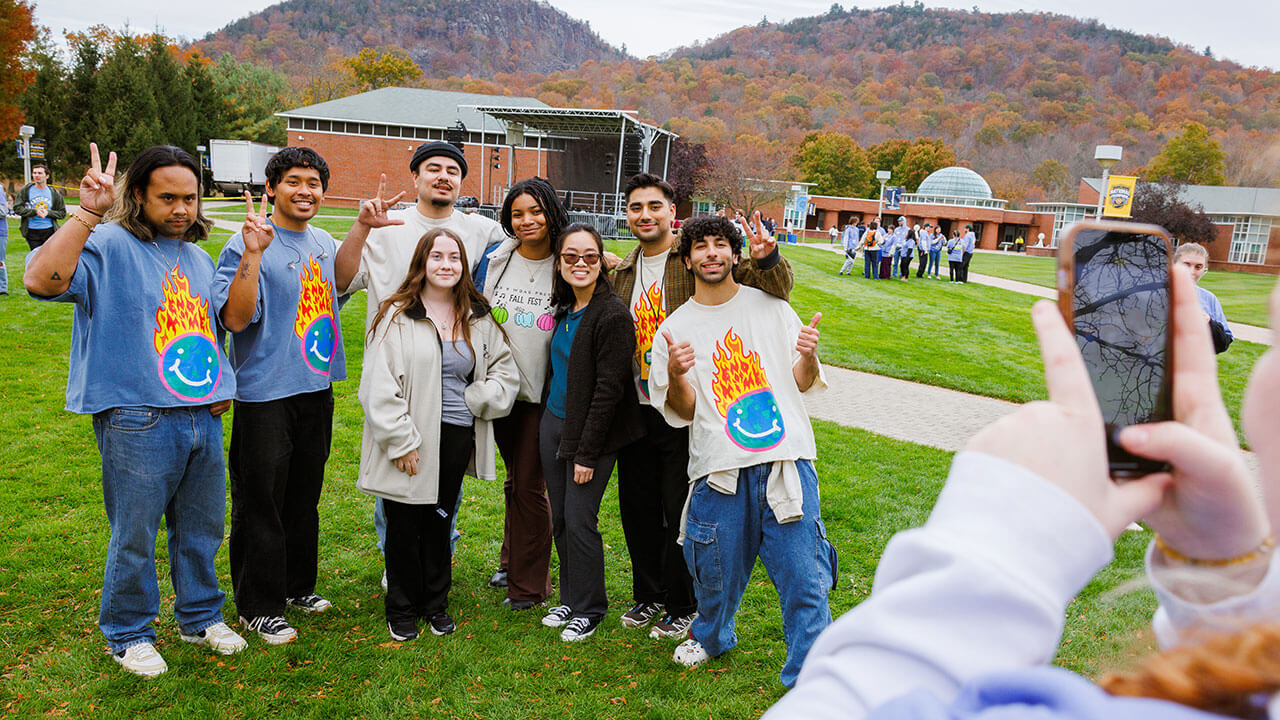 Peach Tree Rascals smiling with students on the quad