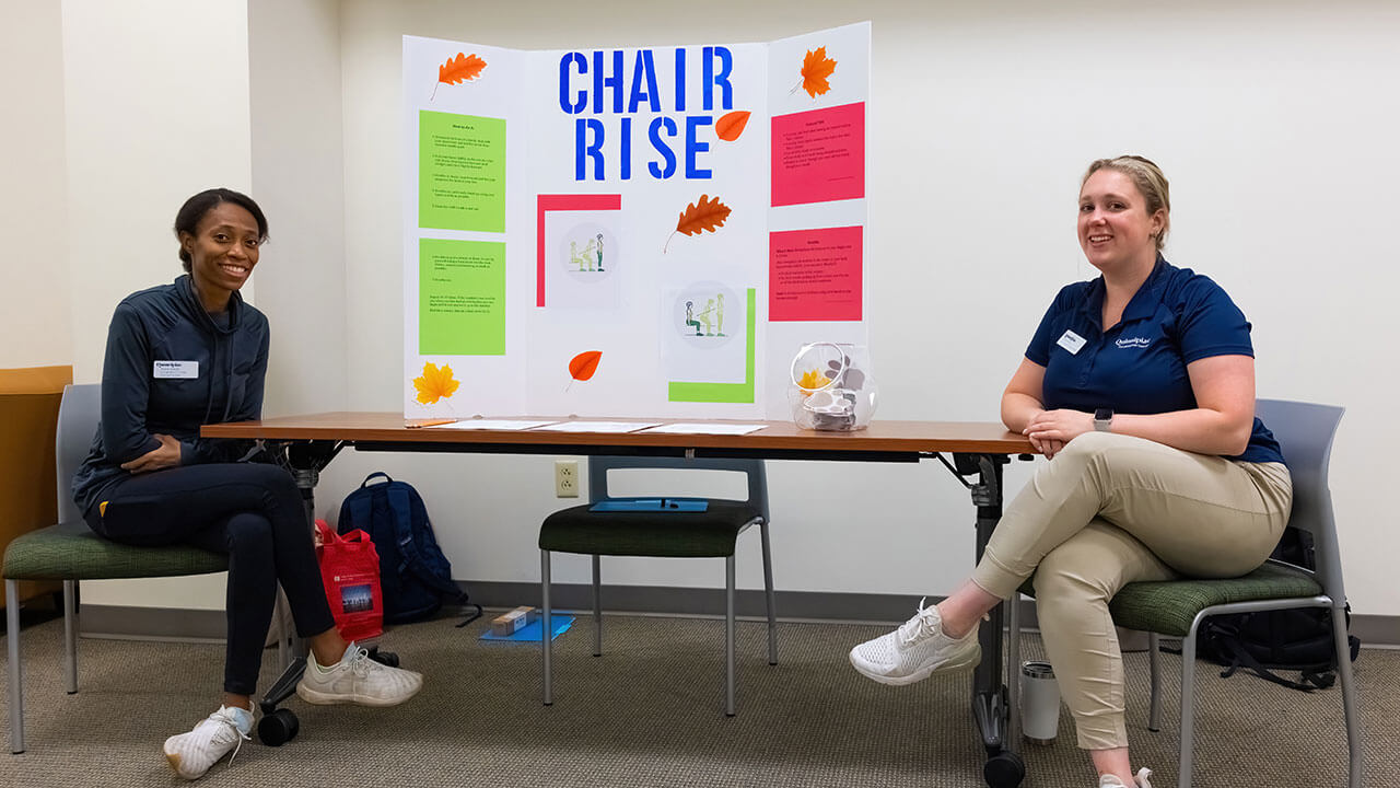 Two students showcase their research on chair rise exercise during Fall Prevention Day