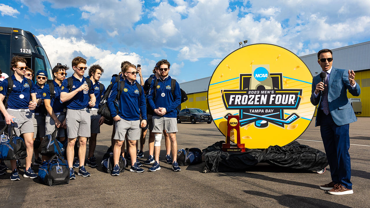 The Quinnipiac ice hockey team smiles for a photo.