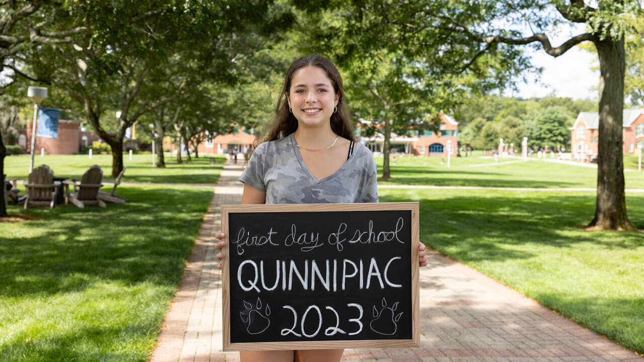 A student poses for a photo on her first day of school