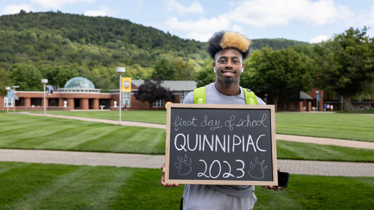 Student poses on the quad