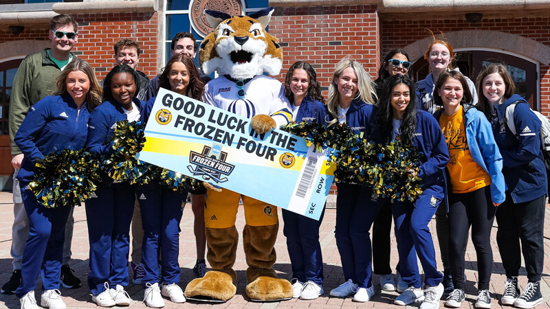 Boomer and the ice cats pose for a group photo on the library steps