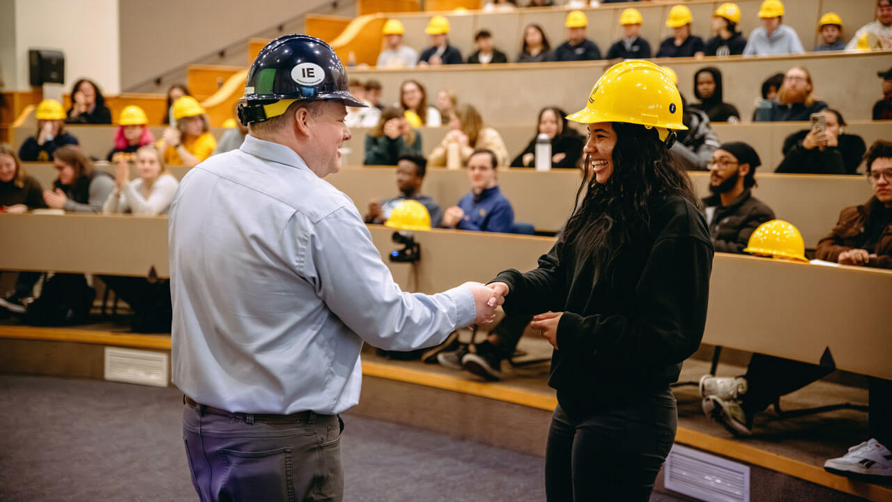 Quinnipiac enigneering student shakes the hand of their professor