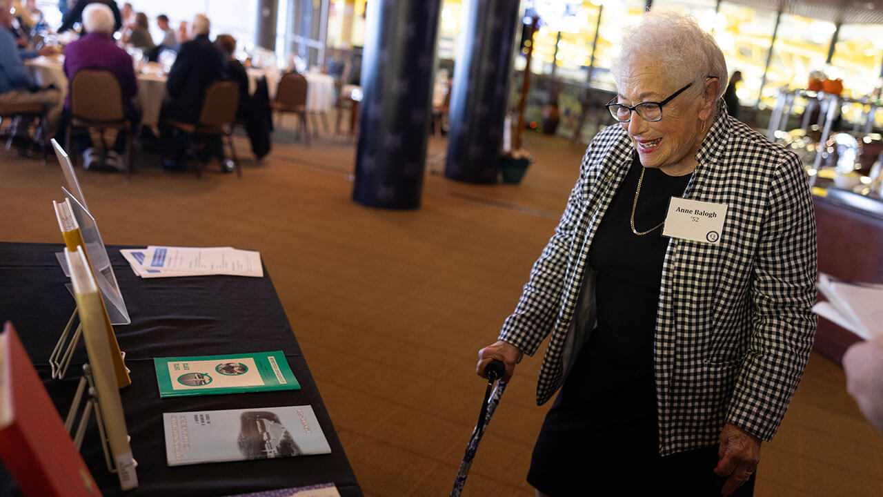 Alumni smiling while looking around at the Alumni Heritage Luncheon