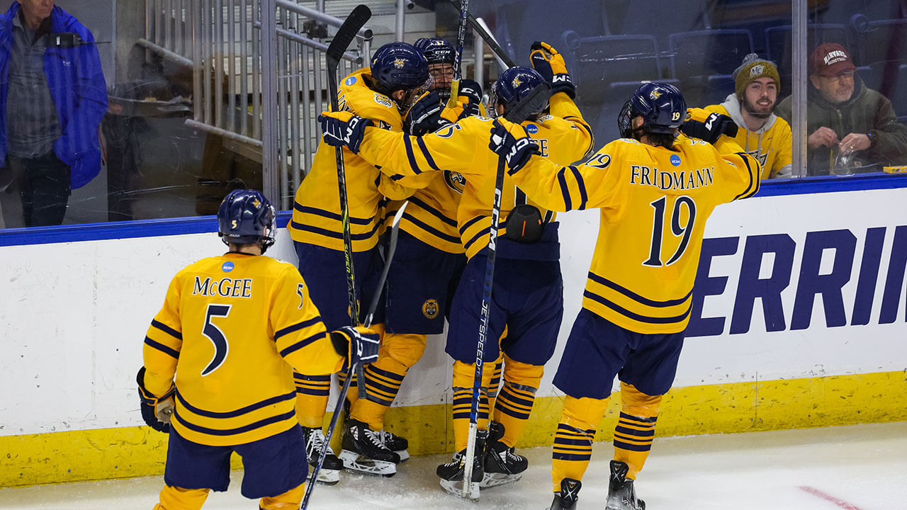 Men's Ice Hockey celebrate a goal against Merrimack