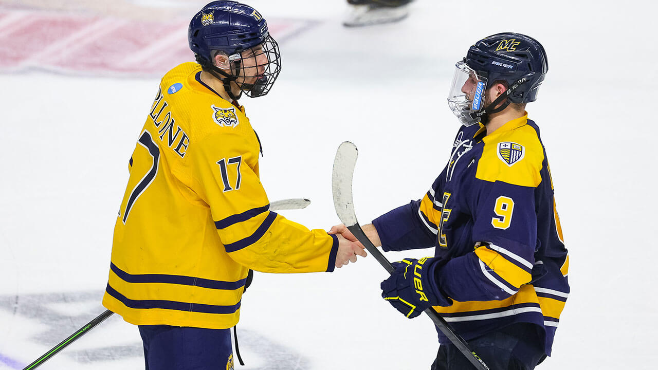 Men's Ice Hockey players shake hands with the Merrimack team