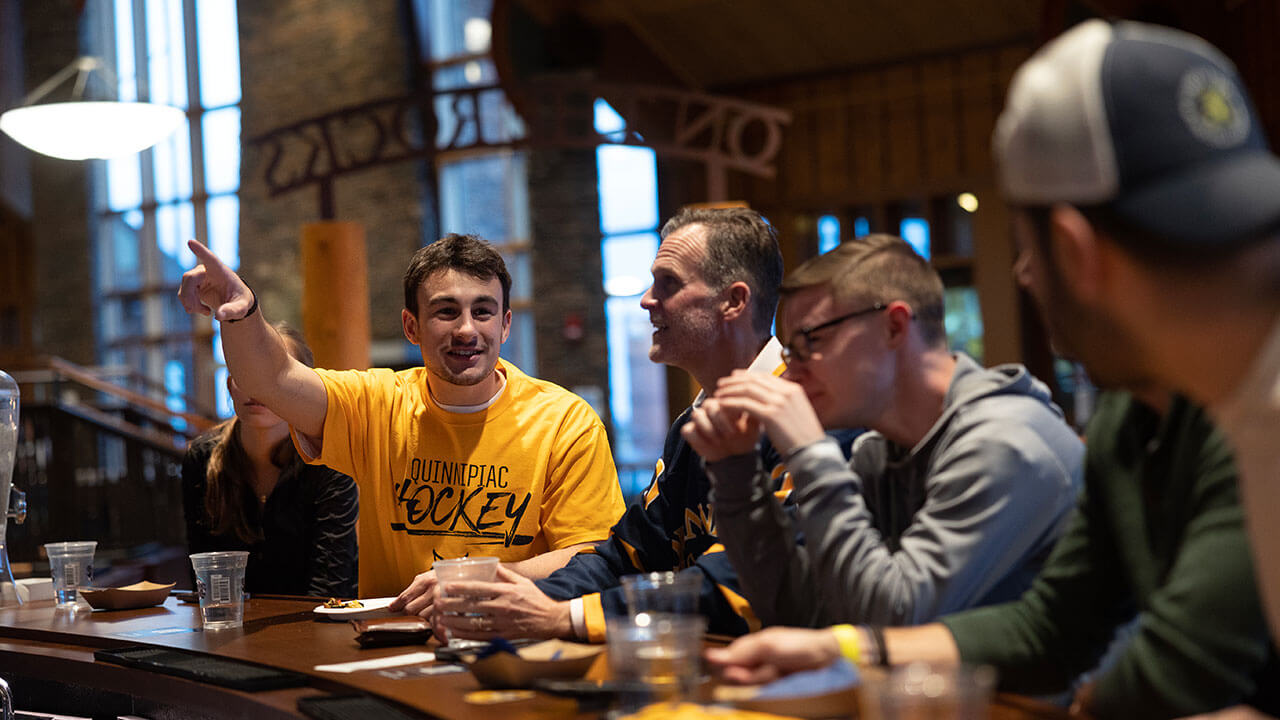 Students sit at the bar at On the Rocks Pub and Grill