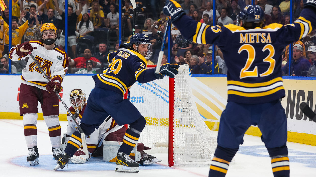 Hockey team scoring goal against Minnesota