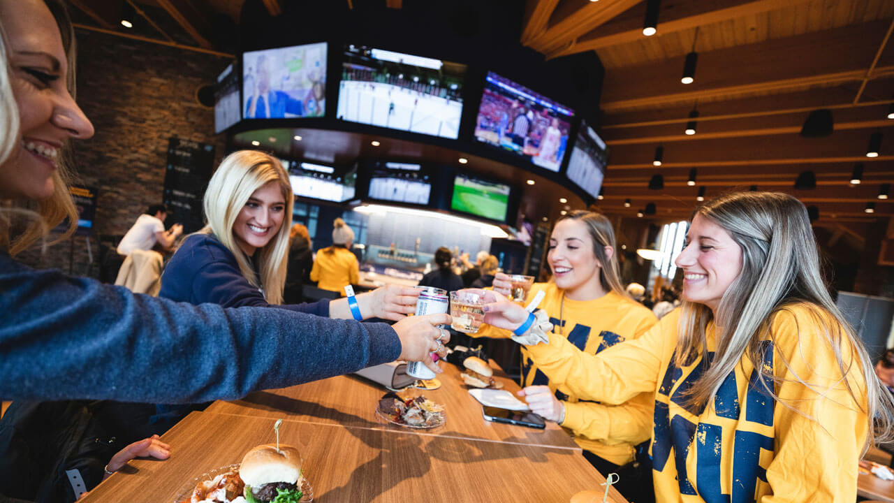 Four students cheers in the pub