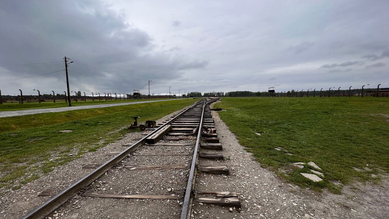 Rail road in the distance with greenery surrounding it